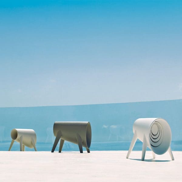 Image of Vondom Bum Bum Toro modern outdoor Bluetooth speakers in different colours on sunny terrace with blue sea and sky in the background