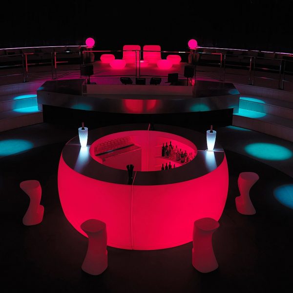 Nighttime image of red illuminated Fiesta circular bar counter island by Vondom