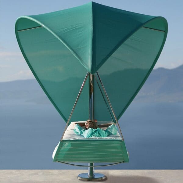 Image of woman lying in turquoise Wave twin hammock by Royal Botania luxury outdoor furniture