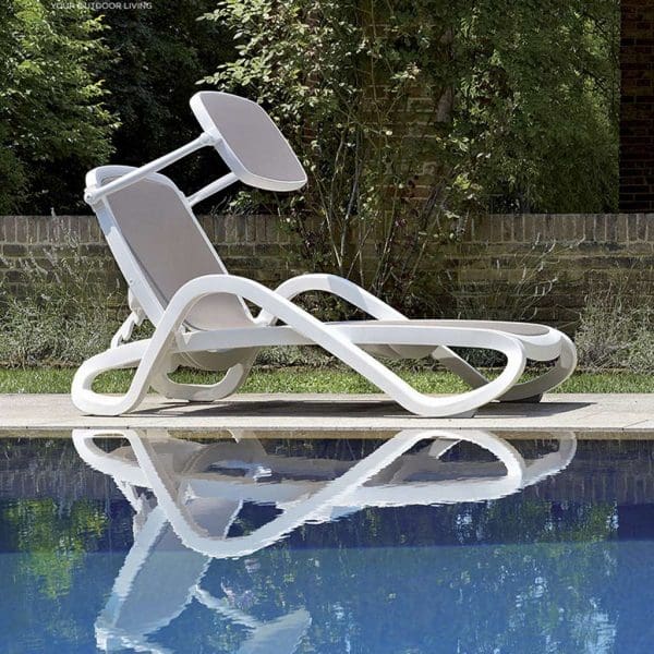 Image of side profile of Alfa low cost sun lounger in white polypropylene by Nardi, shown on poolside with reflection of the lounger shown in the water below