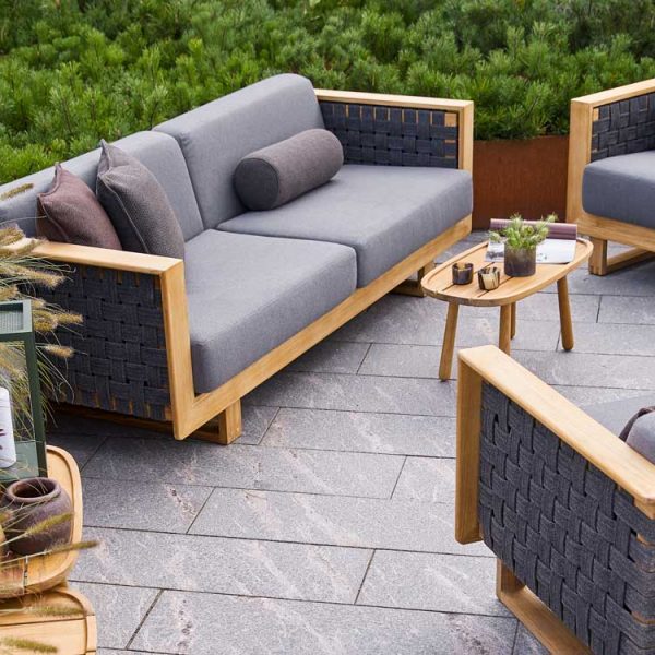 Image of Cane-line Angle outdoor lounge furniture with teak frames and grey AirTouch fabric cushions