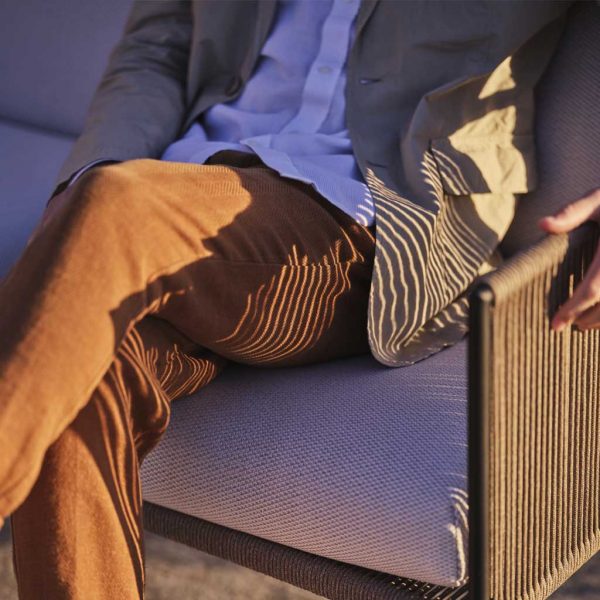 Image of gent sat in Antibes 2 seat garden sofa designed by Broberg & Ridderstråle for Roshults