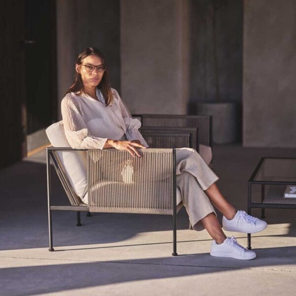 Image of woman sat in Antibes garden lounge chair