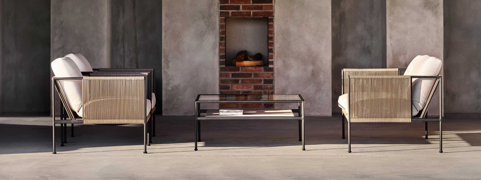 Image from side of Antibes contemporary garden lounge chairs with anthracite stainless steel frames and sand coloured rope sides and back
