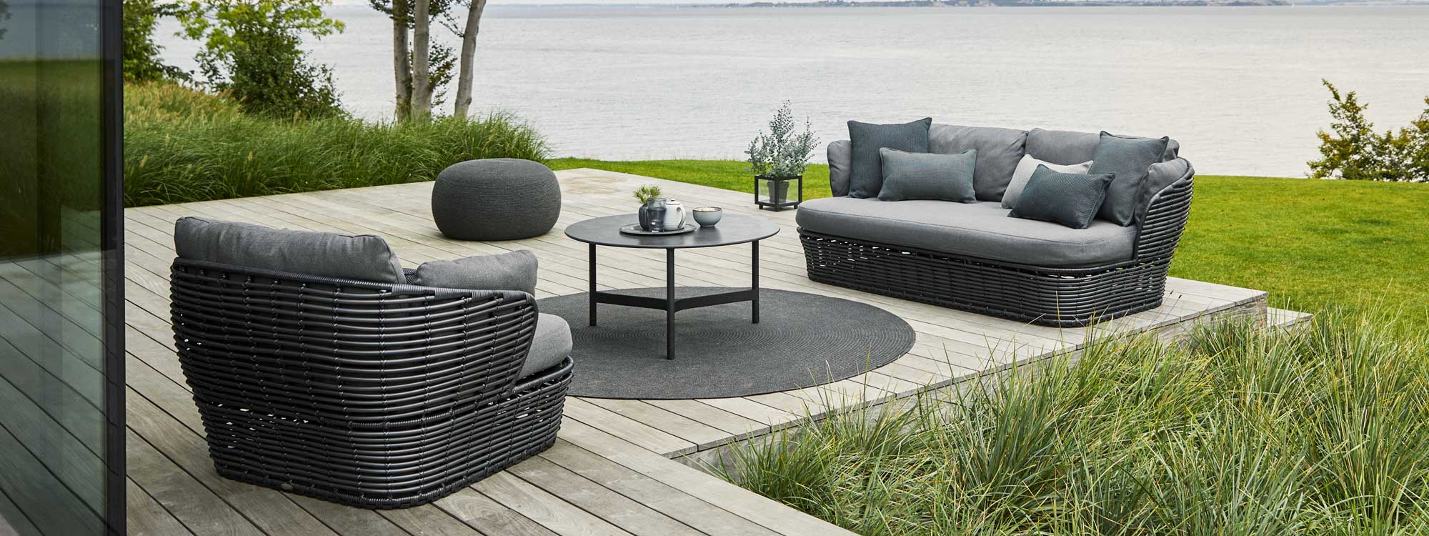 Image of Cane-line Basket furniture in graphite colour with grey cushions