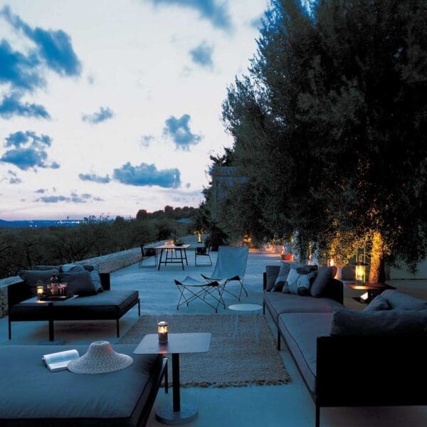 Image of Basket luxury outdoor lounge set and Lawrence butterfly chair in terrace at dusk
