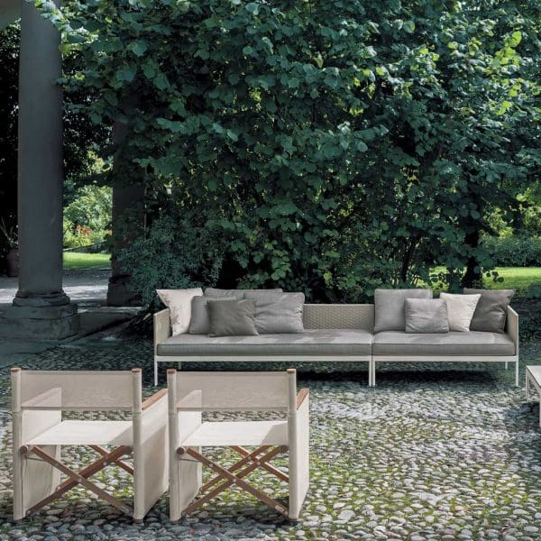 Image of pair of Orson modern outdoor director chairs and long Basket garden sofa on cobbled floor