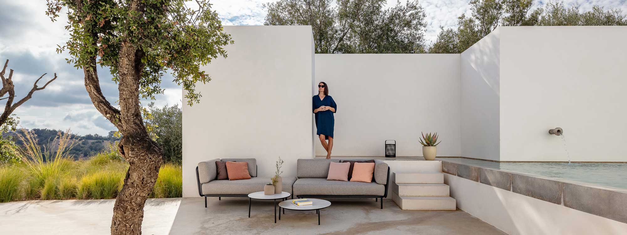 Image of Baza modern outdoor sofa on Portuguese terrace between olive tree and swimming pool