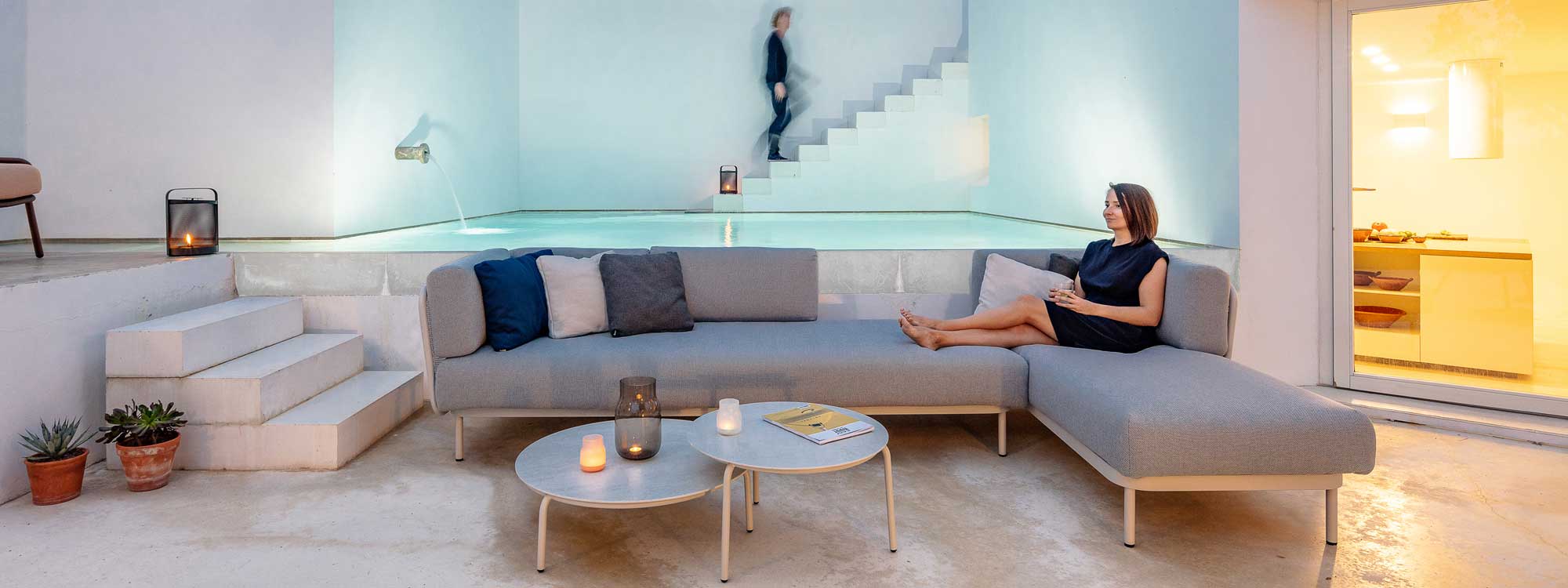 Image of Baza modern outdoor corner sofa & Starling low tables in architectural terrace with swimming pool and staircase in background