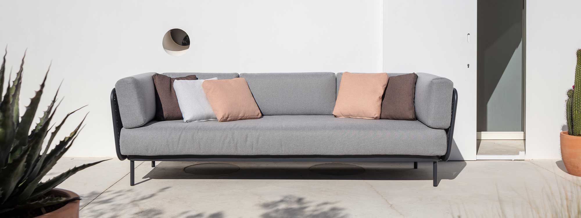 Image of anthracite Baza 3 seat garden sofa by Todus, shown against sunny white-washed wall