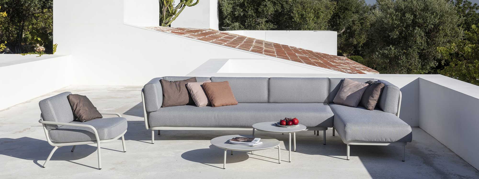 Image of white Baza garden sofa and Starling longer chair & low tables on sizzling hot terrace