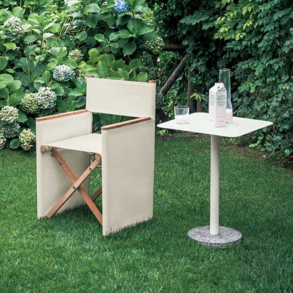 Image of white Orson director chair and Bernardo exterior side table on green grass