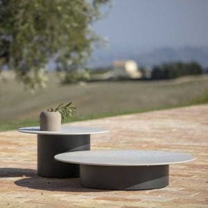 Image of pair of Todus Branta outdoor low tables with broad circular bases and ceramic table tops