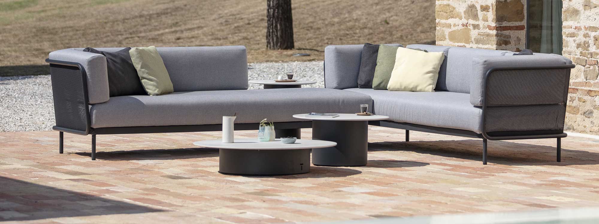 Image showing 3 different heights of Branta outdoor side tables and low tables next to Baza modern garden corner sofa by Todus