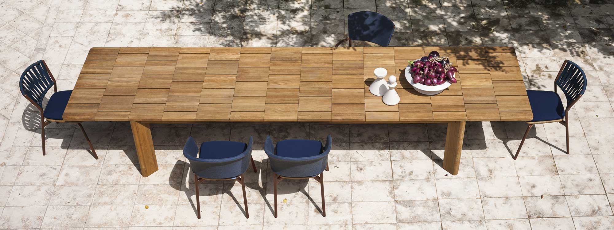 Image of aerial view of RODA Brick extendable teak dining table with Piper garden chairs on sunny terrace