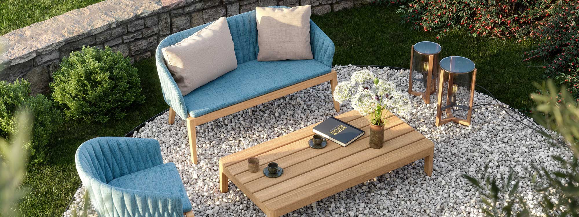 Birdseye view of Royal Botania Calypso outdoor sofa and table in teak with blue upholstery