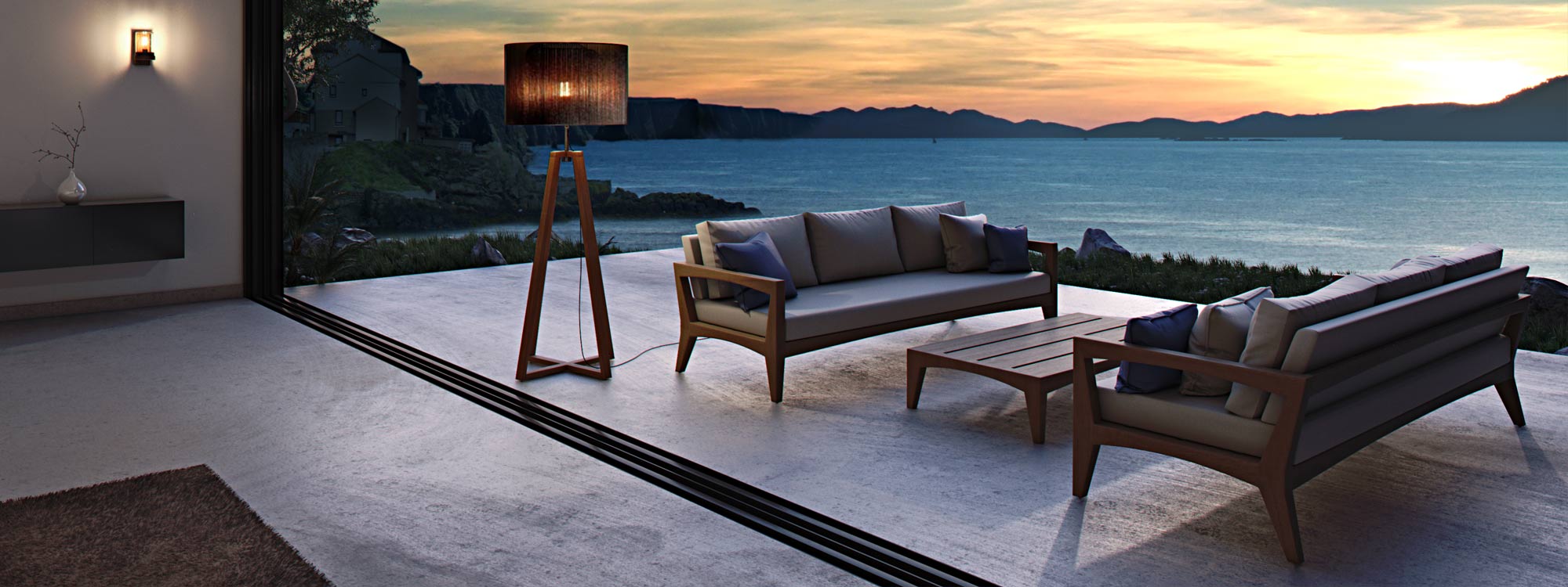 Image of Royal Botania Club outdoor floor light on terrace at dusk, with Zenhit teak garden sofas, sea and headlands in the background