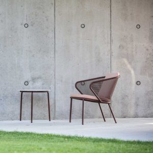 Image of Condor garden chair and Starling outdoor side table in rust-brown finish on terrace