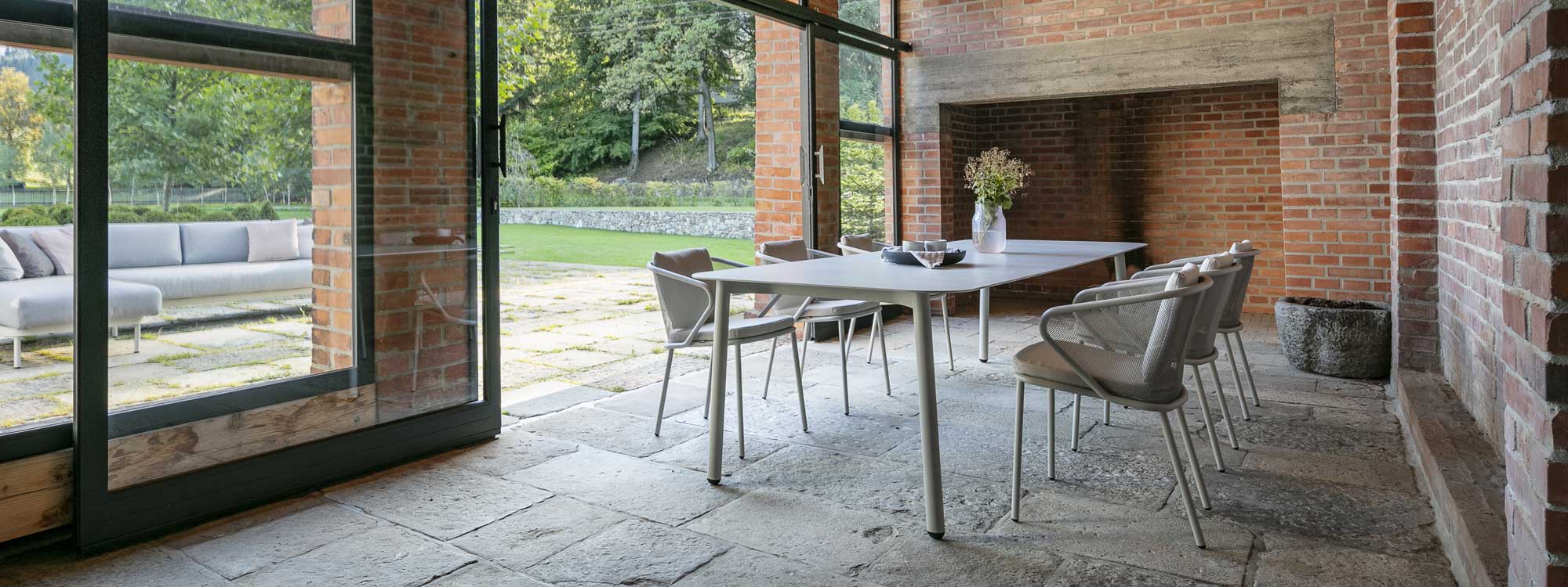 Image of Starling white garden dining table and Condor white outdoor chairs in rustic garden room