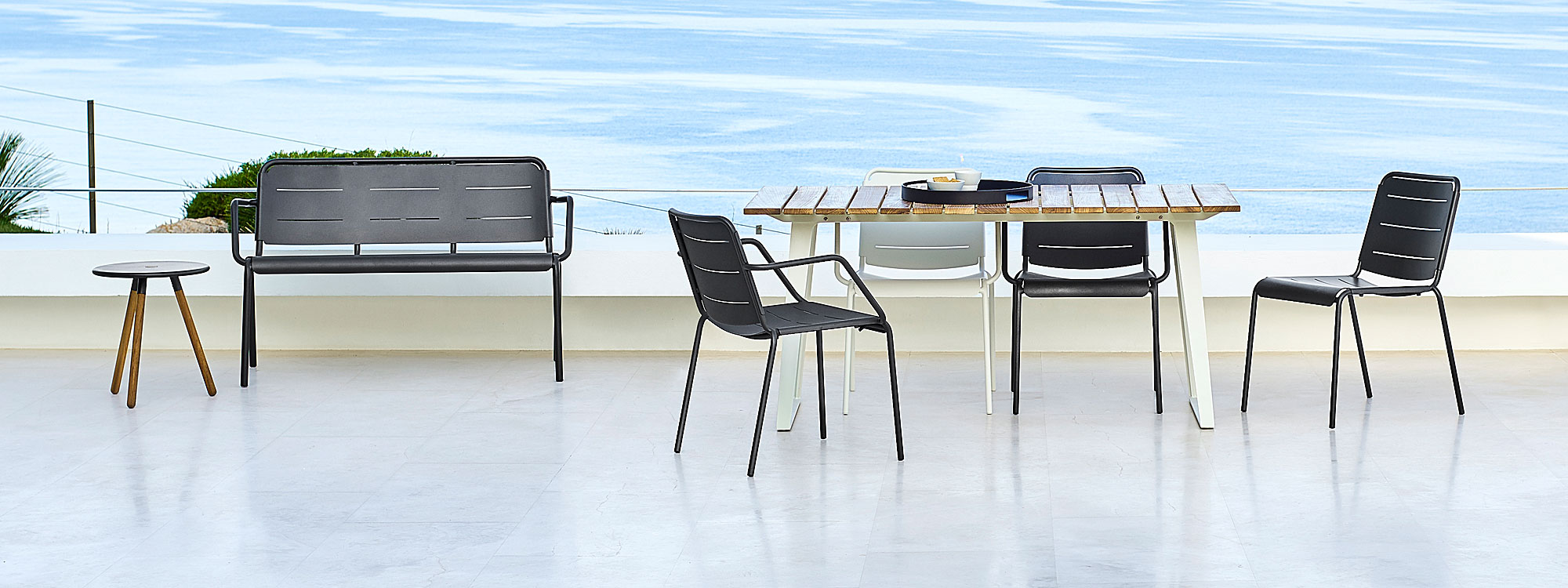 Image of Copenhagen modern aluminum garden furniture by Cane-line on terrace overlooking sea