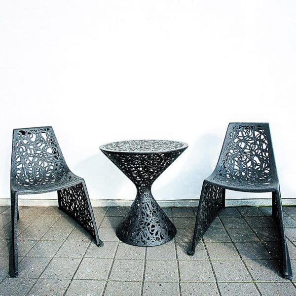 Image of 2 X chairs next to hourglass-shaped Race table by Unknown Nordic furniture