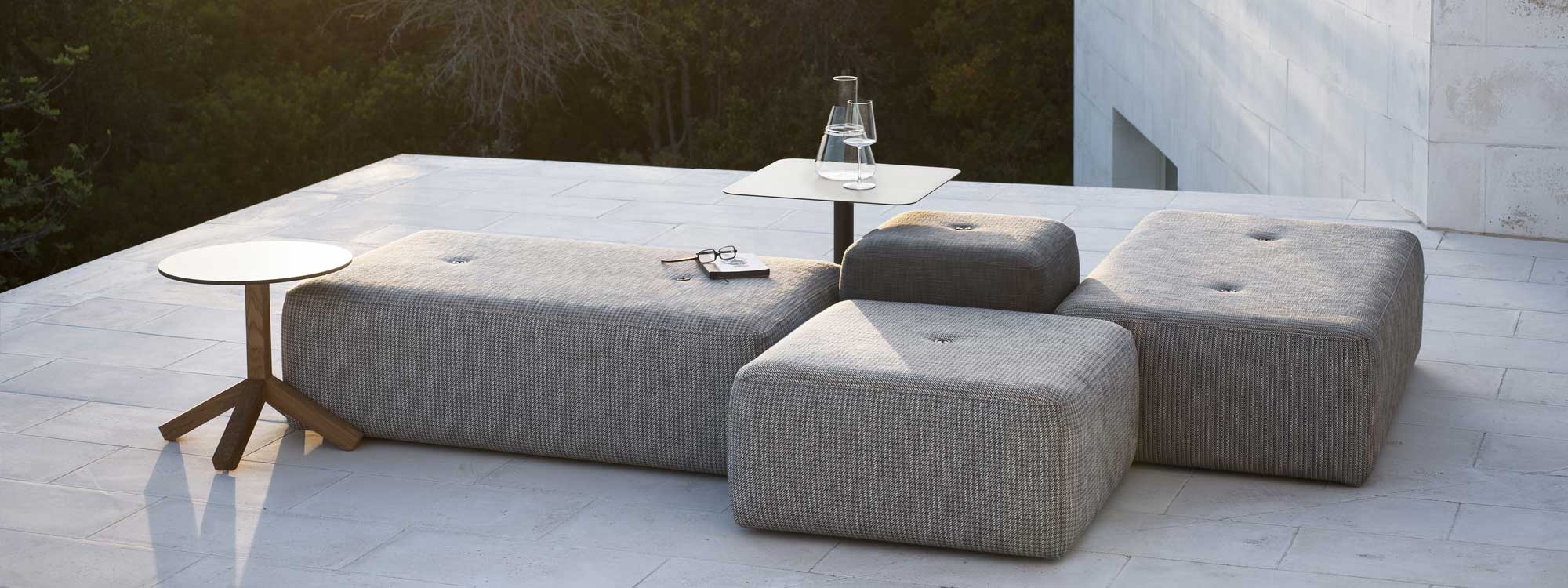 Image of configuration of rectangular and square Double outdoor poufs, together with Bernardo and Root modern side tables by RODA