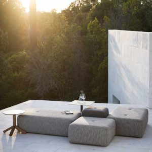 Image of Double rectangular and square garden poufs by RODA, shown on sleek terrace at sunset