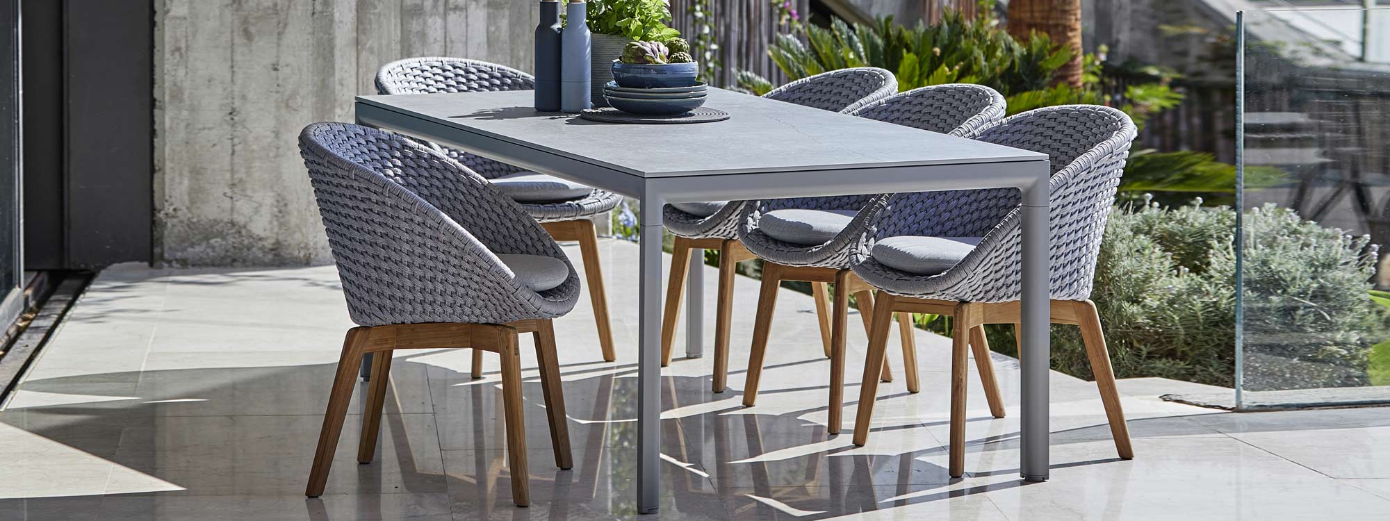 Image of light-grey Drop garden table and light-grey and teak Peacock garden chairs by Cane-line
