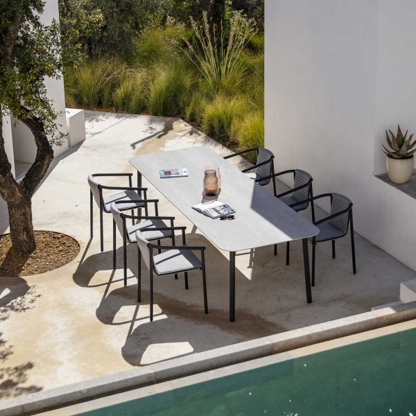 Image of Todus Duct Round garden armchair and Starling modern rectangular garden table in light and shade of white-washed courtyard with alluring plunge pool in foreground