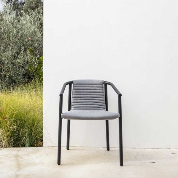 Image of front of Duct Round upholstered garden chair on whitewashed terrace