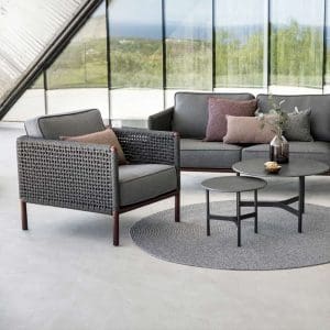 Image of Cane-line Encore outdoor lounge chair and sofa, together with Twist ceramic low tables in the center