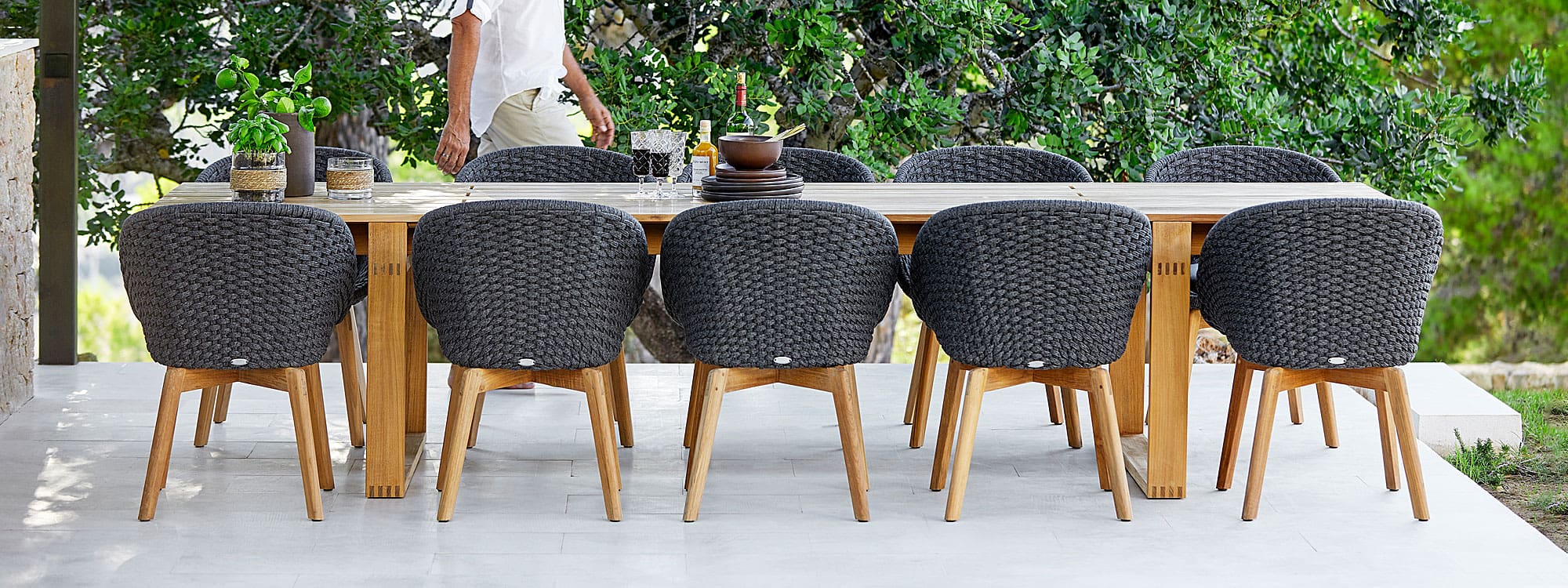 Image of Endless large rectangular teak table and dark grey Soft Rope and teak Peacock garden chairs by Cane-line