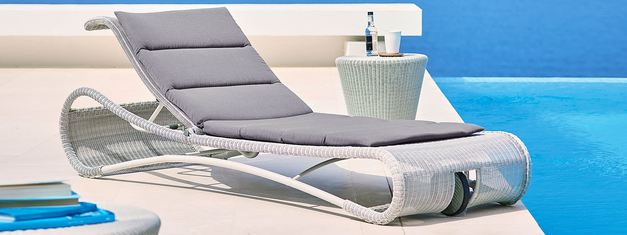 Image of white-grey rattan Escape sunbed with white grey rattan Kingston side table by Cane-line
