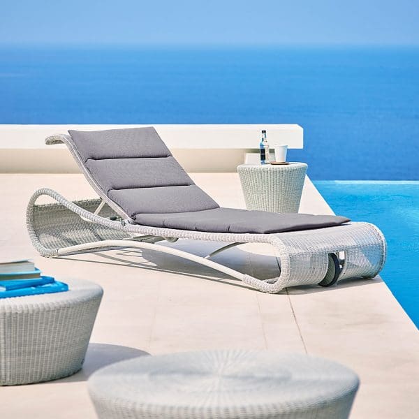 Image of white-grey synthetic rattan Escape sunbed with white-grey Kingston low tables by Cane-line
