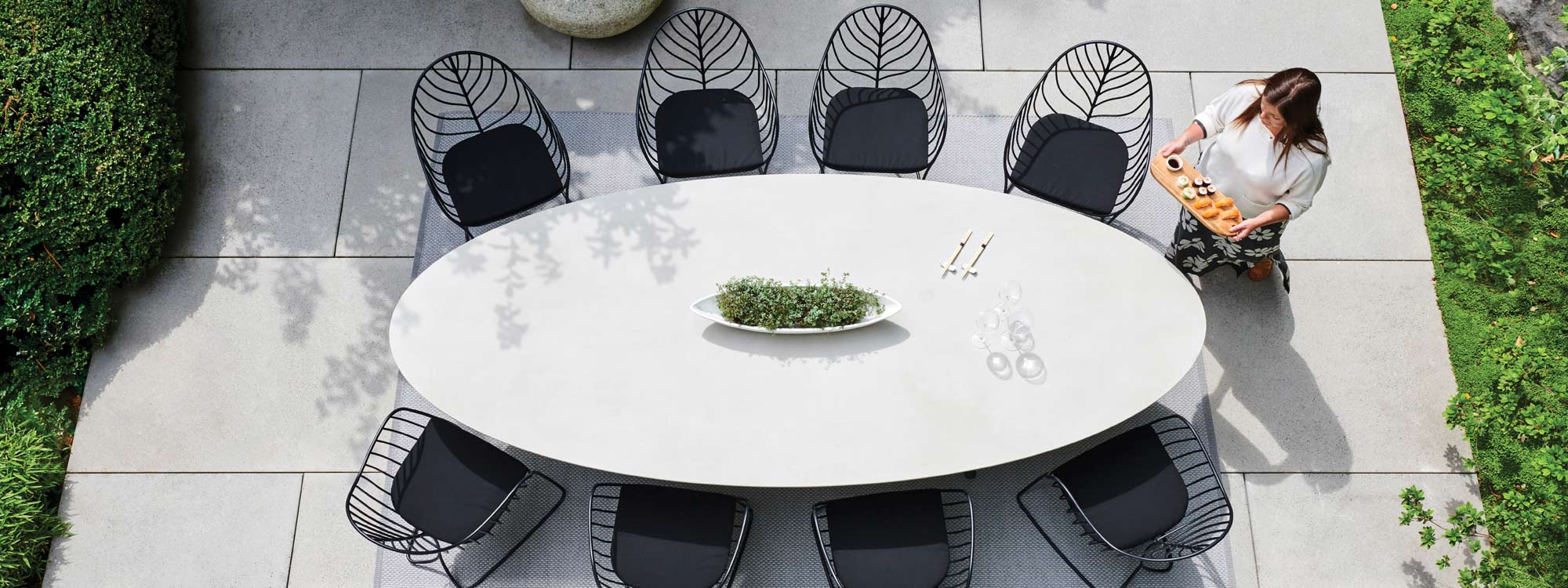 Birdseye Image of Exes elliptical ceramic garden table and Folia chairs by Royal Botania