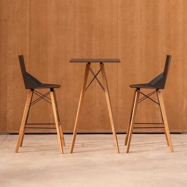 Image of Vondom Faz Wood geometric bar table and high bar chairs with black surfaces