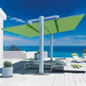 Image of Flexy Large retractable sun shade over Coro L3 sun loungers on sunny terrace with azure sea in background