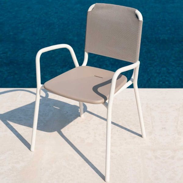 Image of RODA Guest stacking garden chair in white tubular aluminum with taupe Batyline back and polyurethane seat next to swimming pool