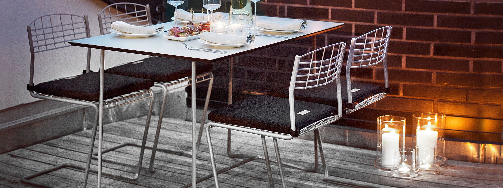 Image of Grythyttan High Tech galvanised garden chair and knock-down table with white Compact laminate table top