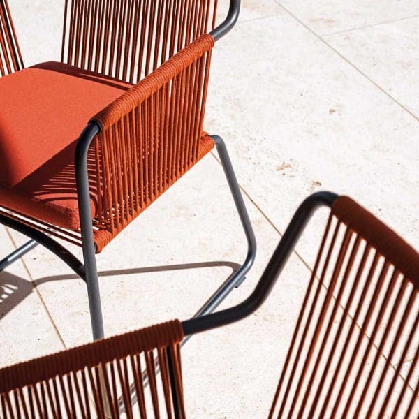 Image of RODA Harp modern garden chairs with smoke-colored frame and orange colored acrylic cord seat, back and arms