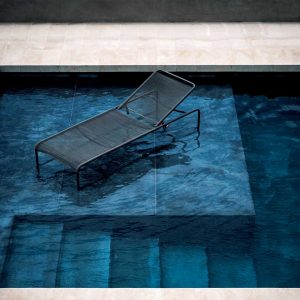 Image of RODA Harp black sun bed shown in shallow water of swimming pool