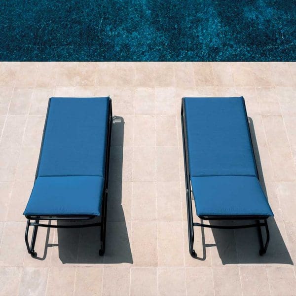Image of aerial view of pair of RODA Harp modern black sun loungers with blue cushions, shown on sunny poolside