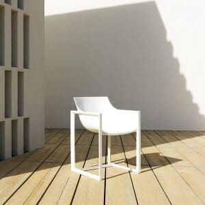 Image of white Wall Street modern plastic hospitality chair by Vondom on sunny wooden decking