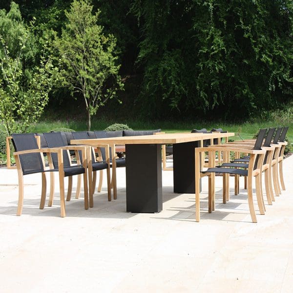 Image of Doble black pedestal garden dining table and XQI teak garden chairs