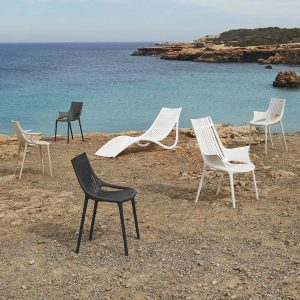 Image of Vondom Ibiza recycled plastic furniture on rocky beach overlooking the Mediterranean