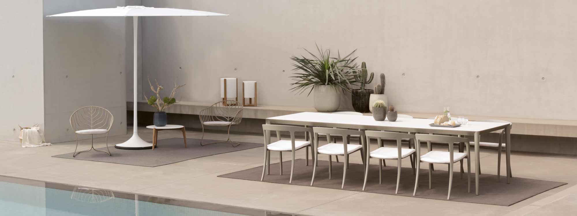 Image of Royal Botania Jive chair in Mushroom finish and U-nite table in Sand finish on chic, minimalist terrace