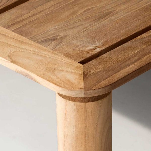 Image of detail of Levante teak table's rounded table top and circular profile table leg by RODA