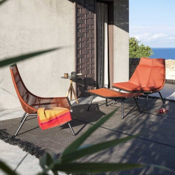 Image of pair of RODA Laze outdoor easy chairs with smoke-colored frames and orange acrylic cord seat & back