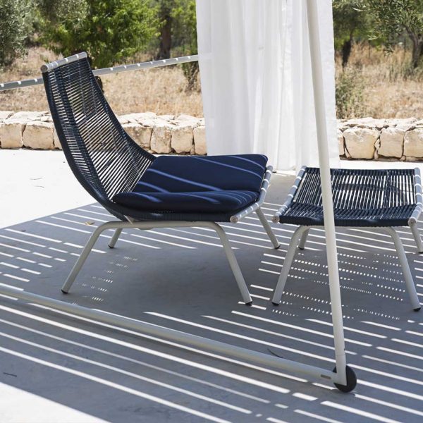 Image of Laze contemporary garden chair and foot stool by Roda with Milk-coloured frame and Blue cords, shown in light and shade beneath Ombrina pergola with wheels