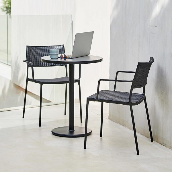 Image of dark-grey Less garden chairs and Go circular bistro table by Cane-line